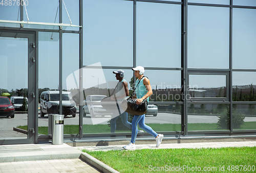 Image of Sports man against modern glassed building, airport in megapolis