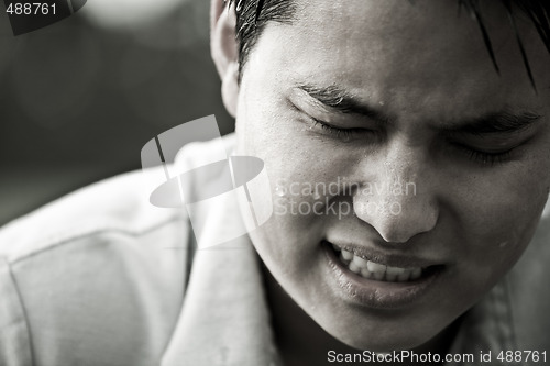 Image of Stressed and depressed asian male