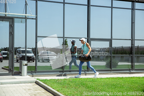 Image of Sports man against modern glassed building, airport in megapolis