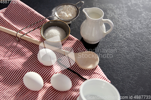 Image of eggs, sugar, milk, flour, spoon and vanilla
