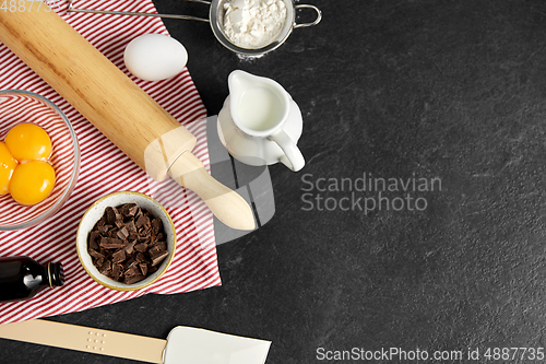 Image of rolling pin, milk, eggs, flour and chocolate