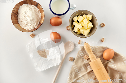 Image of rolling pin, butter, eggs, flour, milk and sugar