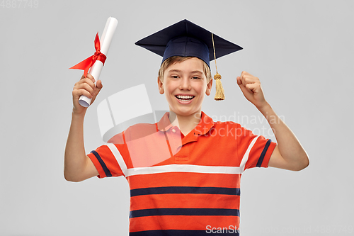Image of graduate student boy in mortarboard with diploma