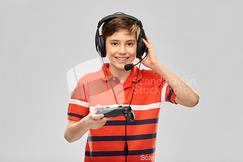 Image of boy in headphones with gamepad playing video game
