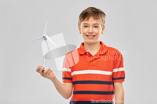 Image of happy smiling boy holding toy wind turbine