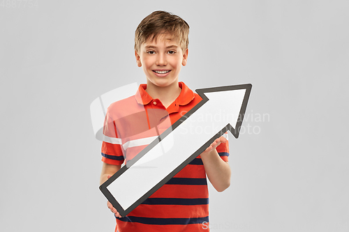 Image of happy boy holding big white rightwards thick arrow