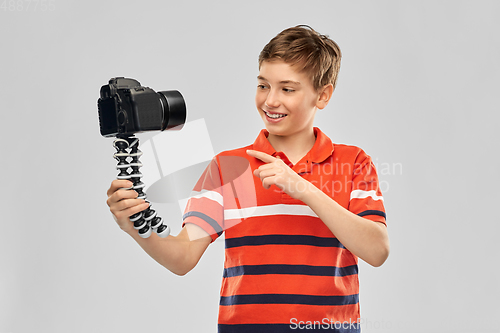 Image of boy video blogger with camera and tripod