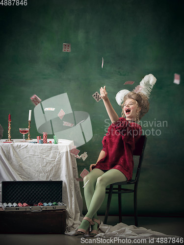 Image of Young woman as Marie Antoinette on dark background. Retro style, comparison of eras concept.