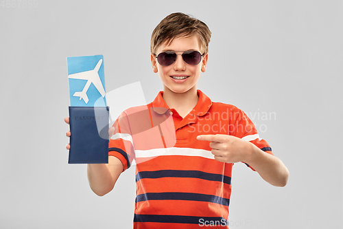 Image of happy boy in sunglasses with ticket and passport