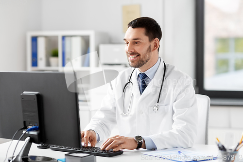 Image of male doctor with computer working at hospital