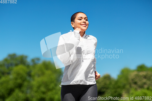 Image of african american woman running outdoors