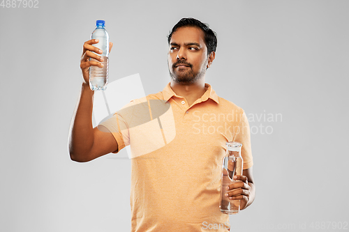 Image of indian man comparing water in different bottles