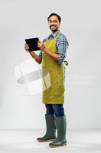 Image of indian male gardener or farmer with tablet pc