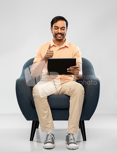 Image of happy indian man with tablet pc showing thumbs up