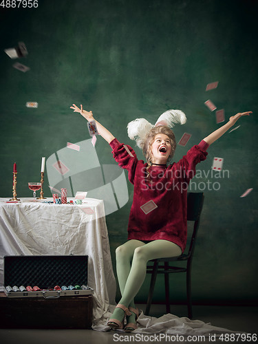 Image of Young woman as Marie Antoinette on dark background. Retro style, comparison of eras concept.