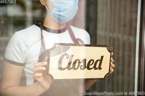 Image of Closed sign on the glass of street cafe or restaurant