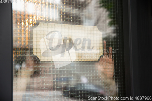 Image of Open sign on the glass of street cafe or restaurant