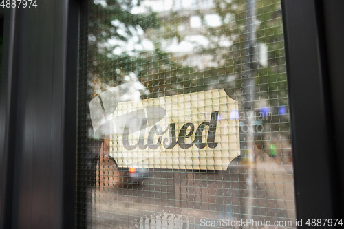 Image of Closed sign on the glass of street cafe or restaurant