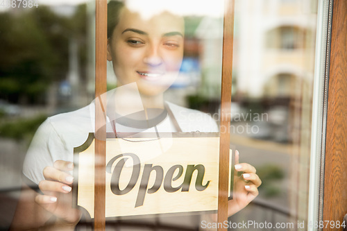 Image of Open sign on the glass of street cafe or restaurant