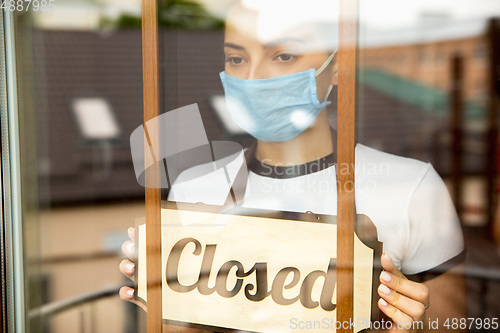 Image of Closed sign on the glass of street cafe or restaurant