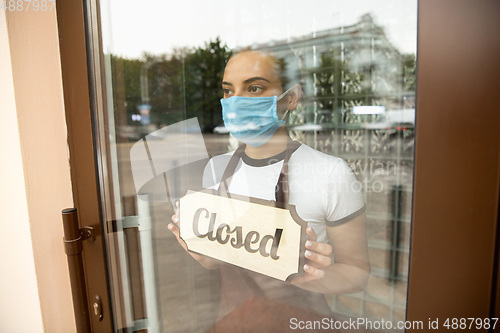 Image of Closed sign on the glass of street cafe or restaurant