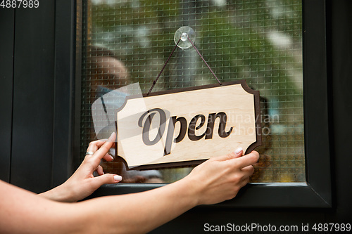 Image of Open sign on the glass of street cafe or restaurant