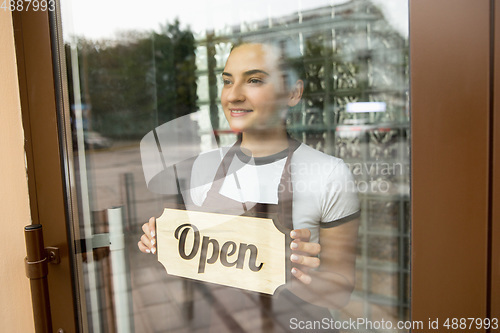 Image of Open sign on the glass of street cafe or restaurant