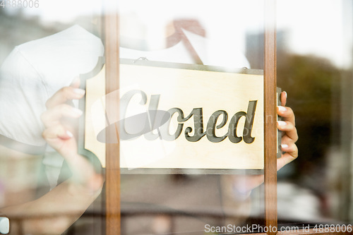 Image of Closed sign on the glass of street cafe or restaurant