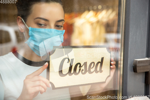 Image of Closed sign on the glass of street cafe or restaurant