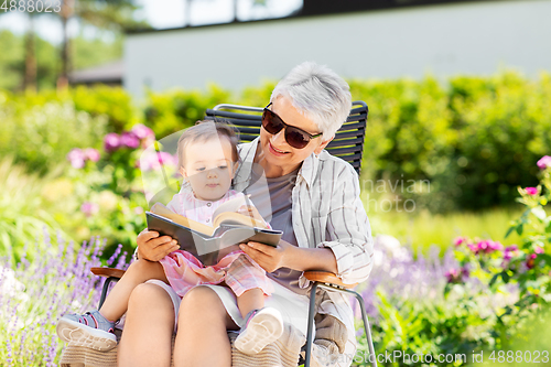 Image of grandmother and baby granddaughter reading book