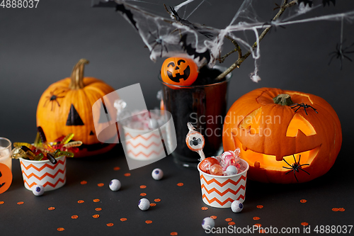 Image of pumpkins, candies and halloween decorations