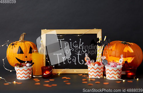 Image of pumpkins, candies and halloween decorations