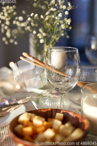 Image of wine glass on served dinner party table at home