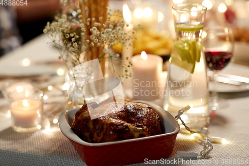 Image of roast chicken on served table at home dinner party