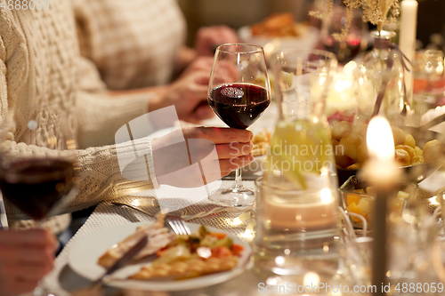 Image of friends drinking red wine at christmas party