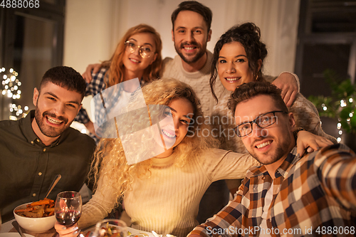 Image of friends taking selfie at christmas dinner party