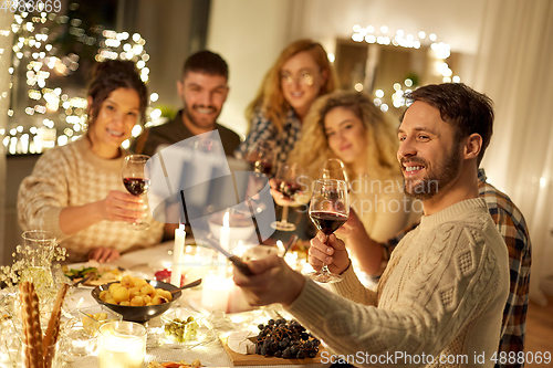 Image of friends taking selfie at christmas dinner party