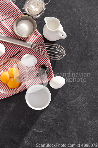 Image of whisk, eggs, sugar, milk, flour and vanilla