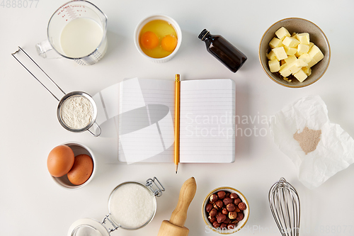 Image of recipe book and cooking ingredients on table