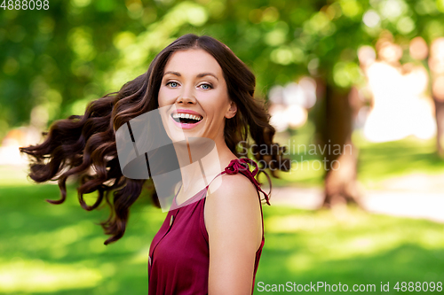 Image of happy smiling woman at summer park