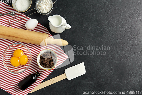 Image of rolling pin, milk, eggs, flour and chocolate