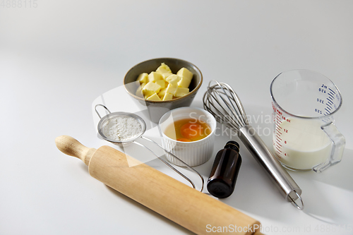 Image of rolling pin, butter, eggs, flour, milk and whisk