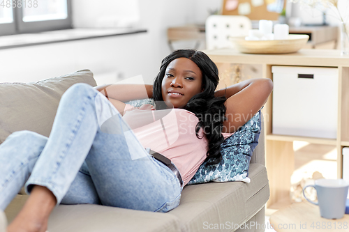 Image of happy african american young woman at home