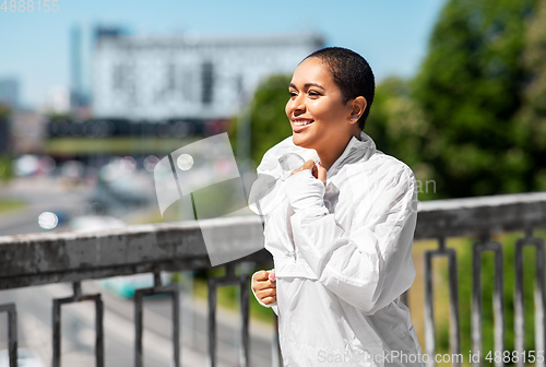 Image of african american woman running outdoors