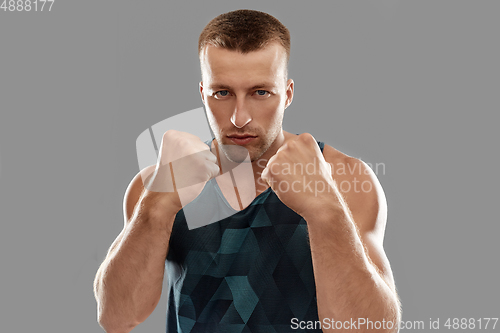 Image of young man or bodybuilder showing his fists