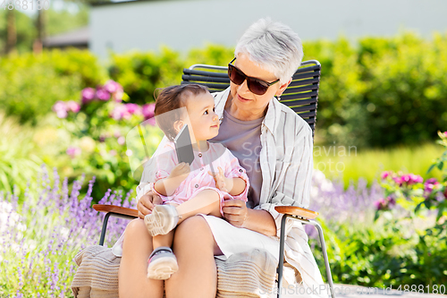 Image of grandmother and baby granddaughter with phone