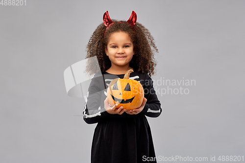 Image of girl in halloween costume with jack-o-lantern