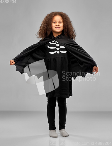 Image of girl in costume of dracula with cape on halloween