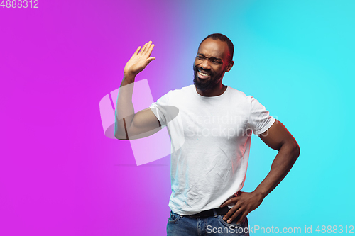 Image of African-american young man\'s portrait on gradient studio background in neon