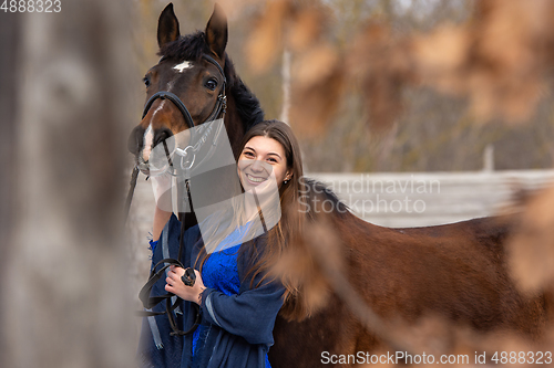 Image of Portrait of a happy beautiful girl of Slavic appearance and a horse